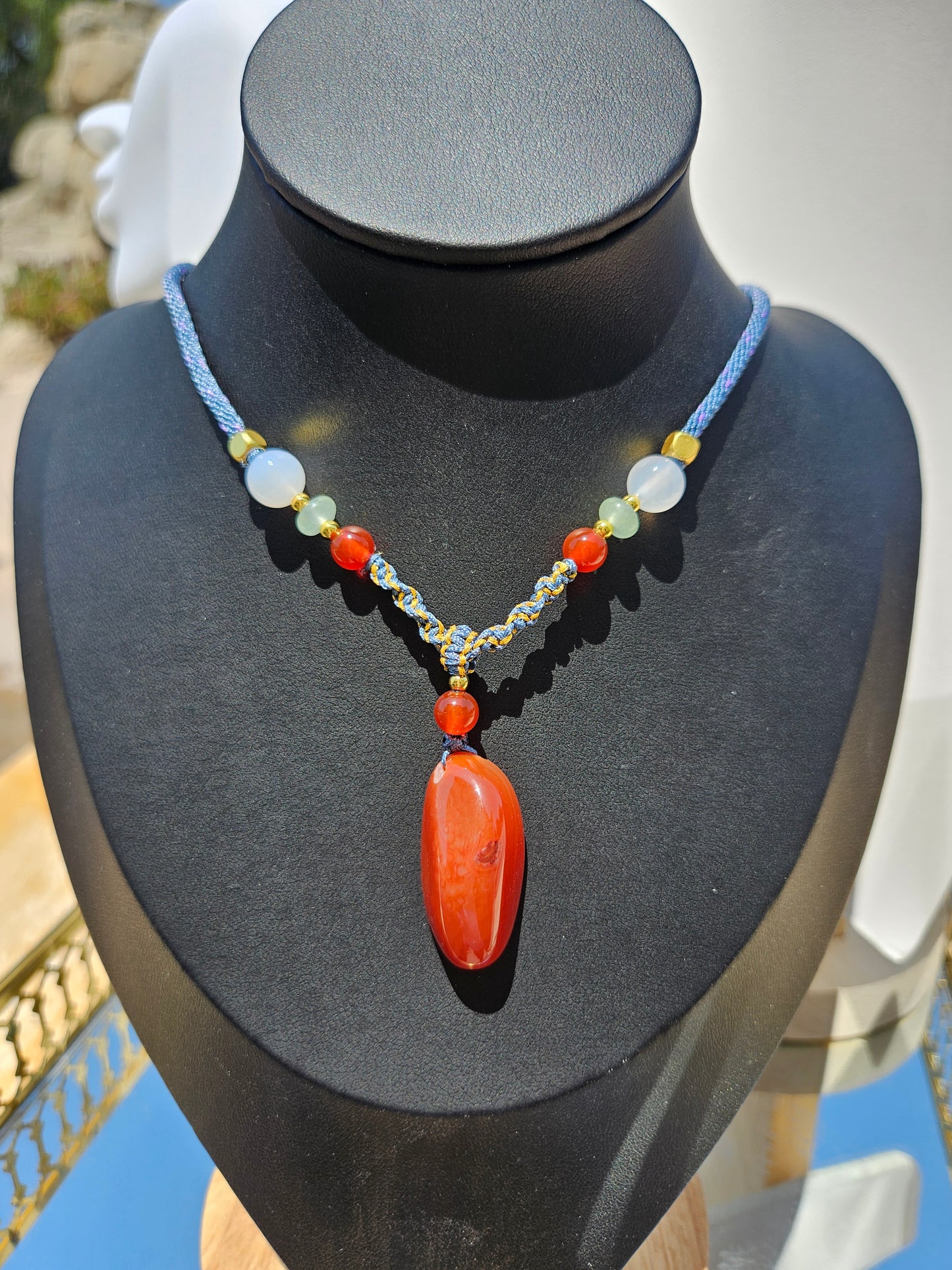 The natural agate pendant necklace has natural different textures on both sides