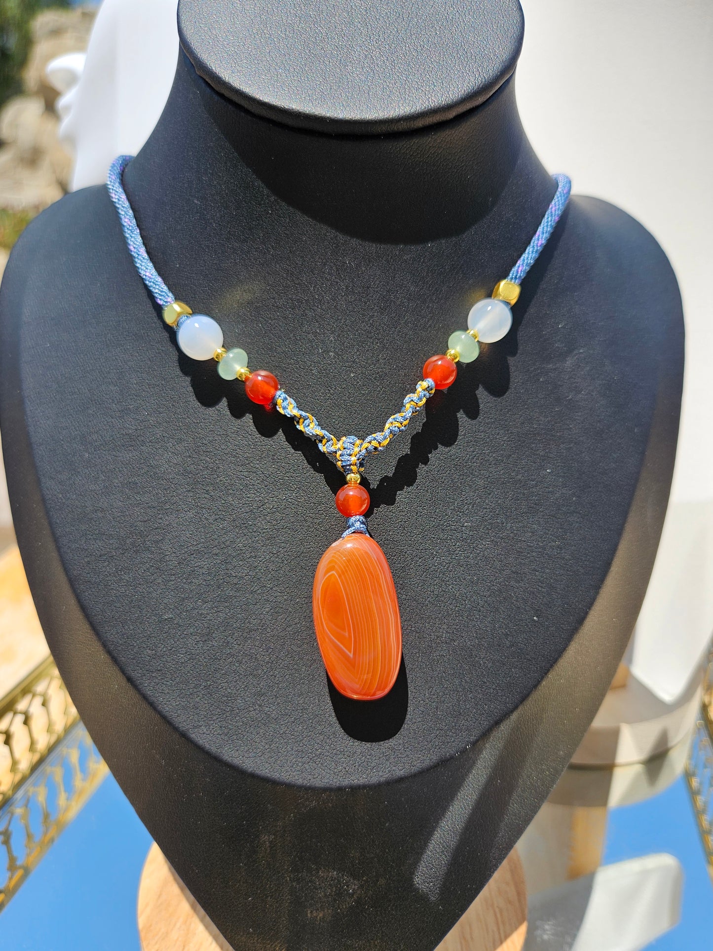 The natural agate pendant necklace has natural different textures on both sides